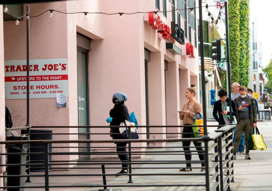 People are waiting to enter a Trader Joe's in West Hollywood on March 31, 2020. (VALERIE MACON/AFP via Getty Images)