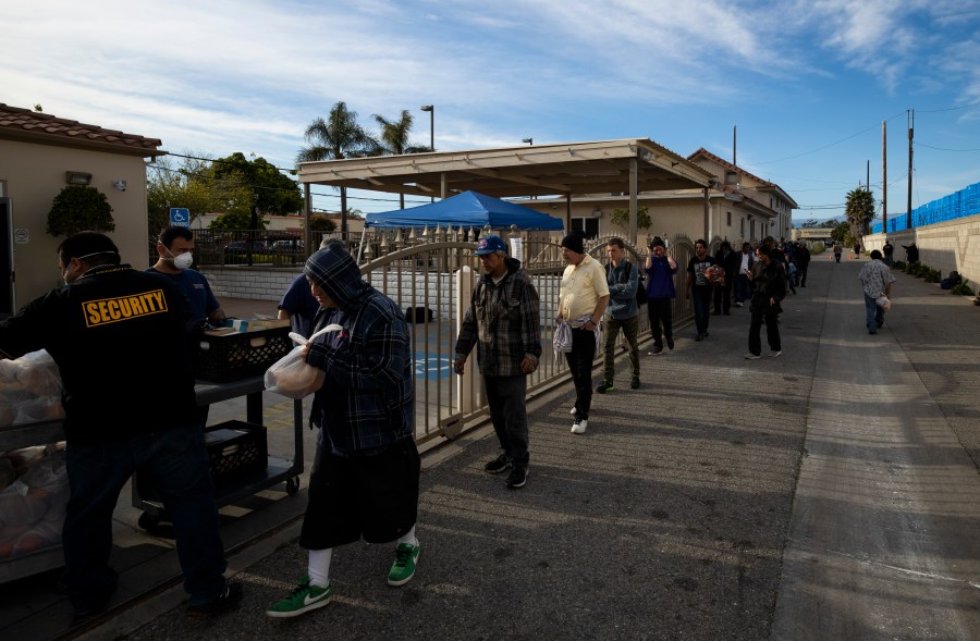 Ventura County Rescue Mission workers hand out food packages to the homeless on March 31, 2020 in Ventura. (Brent Stirton/Getty Images)