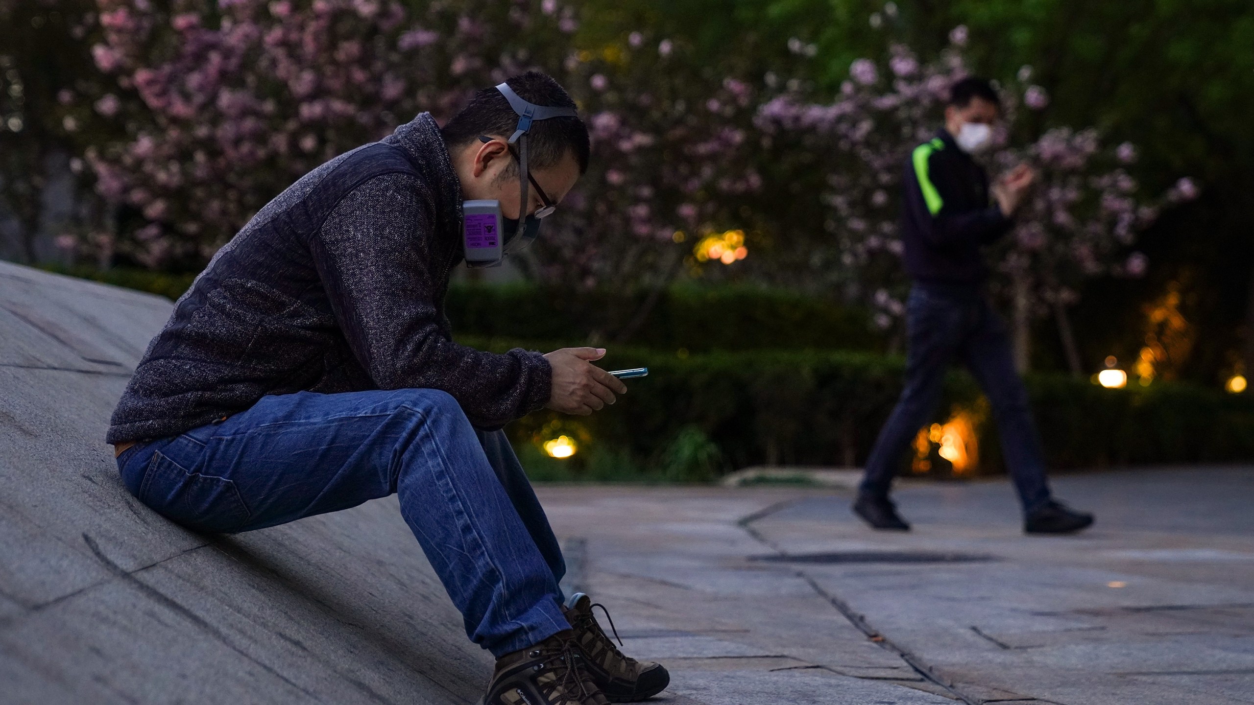 A Chinese man wears a protective mask as they he sit outside a shopping mall on April 12, 2020, in Beijing, China. (Lintao Zhang/Getty Images)