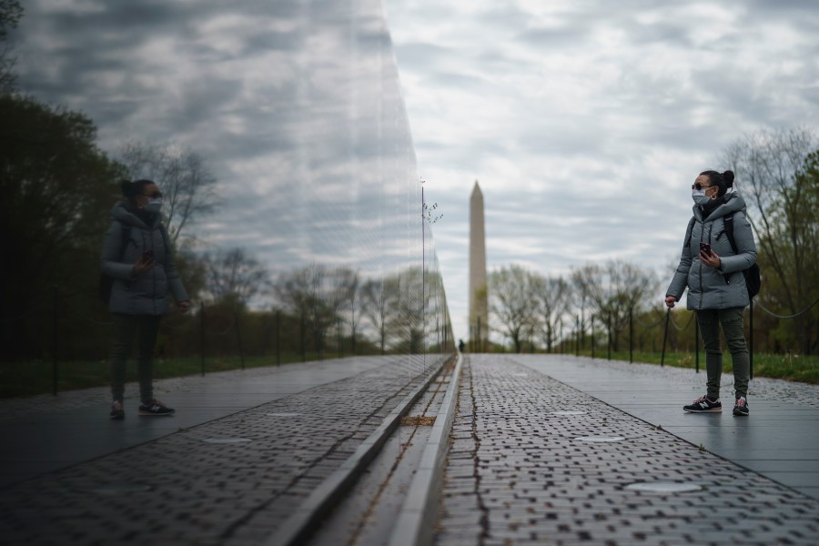 A woman visits an empty Vietnam Veterans Memorial on April 14, 2020, in Washington, D.C. (Drew Angerer/Getty Images)