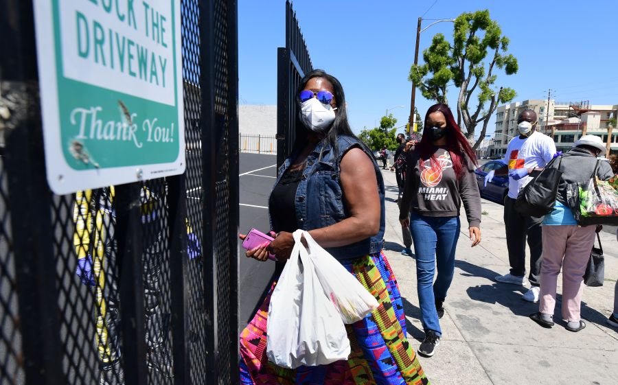 People enter the 88th Street Temple Church of God in Christ for an emergency food distribution on April 14, 2020 in Los Angeles. (Frederic J. Brown/AFP via Getty Images)