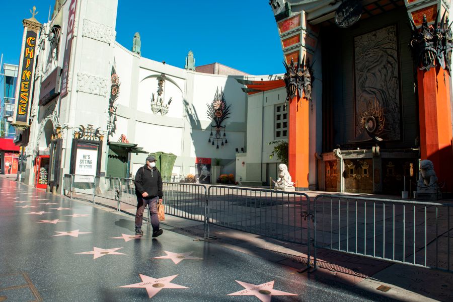 A person wearing a mask walks past the TCL Chinese Theater during the COVID-19 crisis on April 15, 2020, in Hollywood, California. (VALERIE MACON/AFP via Getty Images)