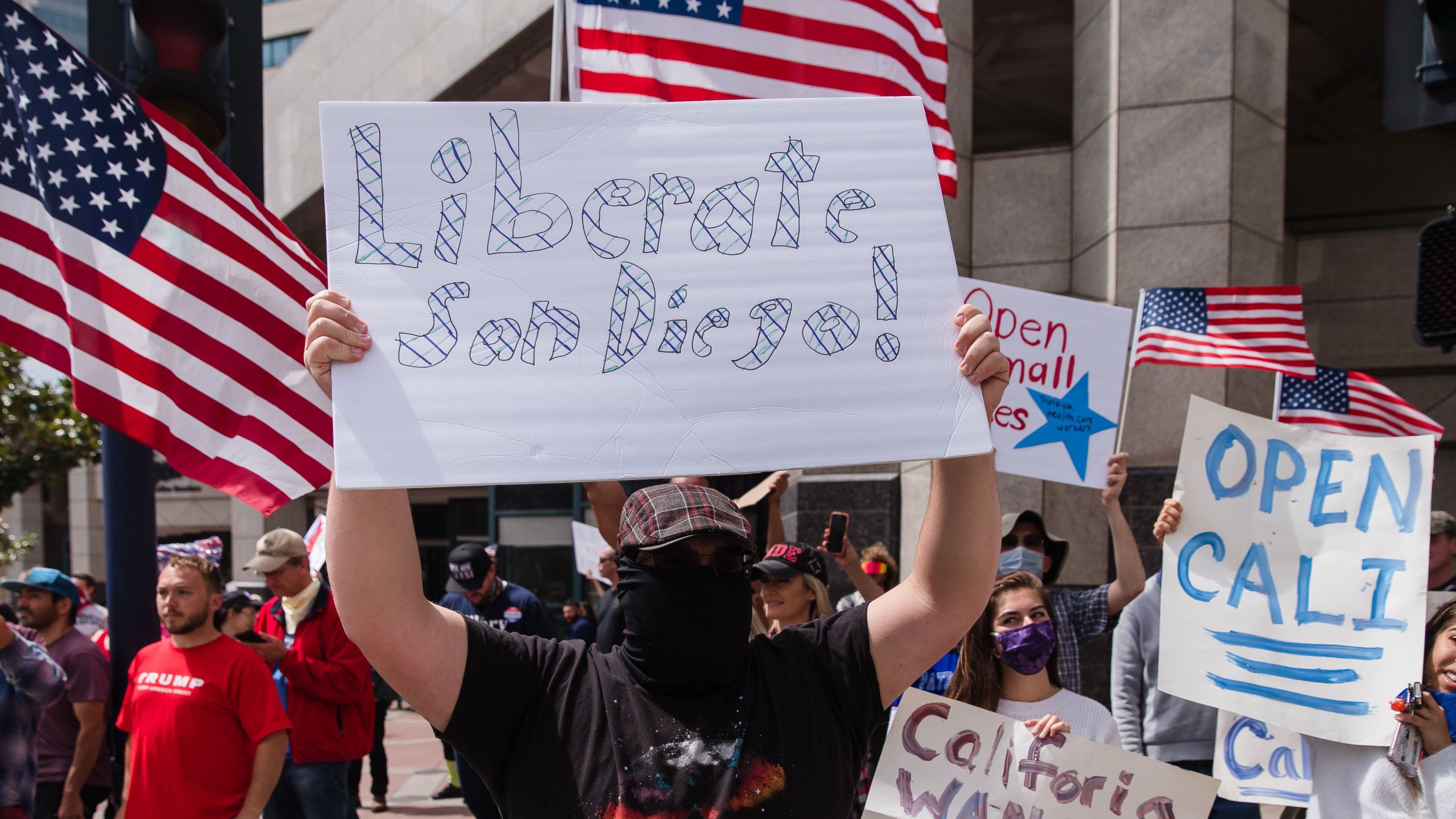 Protesters rally in downtown San Diego against California's stay-at-home order to prevent the spread of the novel coronavirus, which causes COVID-19, on April 18, 2020. (ARIANA DREHSLER/AFP via Getty Images)