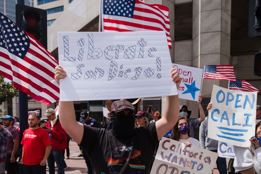 Protesters rally in downtown San Diego against California's stay-at-home order to prevent the spread of the novel coronavirus, which causes COVID-19, on April 18, 2020. (ARIANA DREHSLER/AFP via Getty Images)