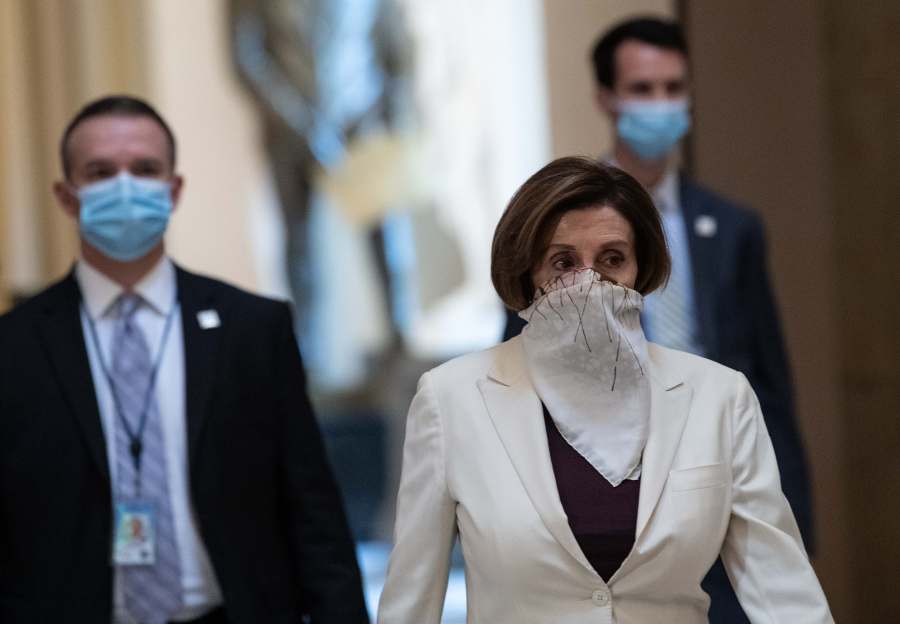 House Speaker Nancy Pelosi walks out of the House chambers after debate on a $480 billion coronavirus relief package on April 23, 2020. (Credit: Nicholas Kamm / AFP / Getty Images)