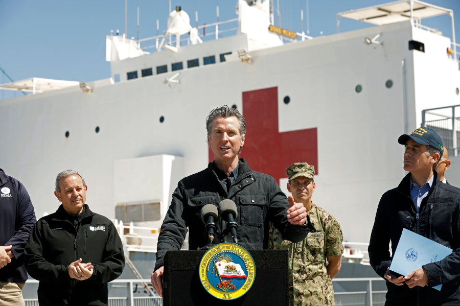 Gov. Gavin Newsom speaks in front of the hospital ship USNS Mercy after it arrived into the Port of Los Angeles on March 27, 2020. (Credit: Carolyn Cole / Getty Images)