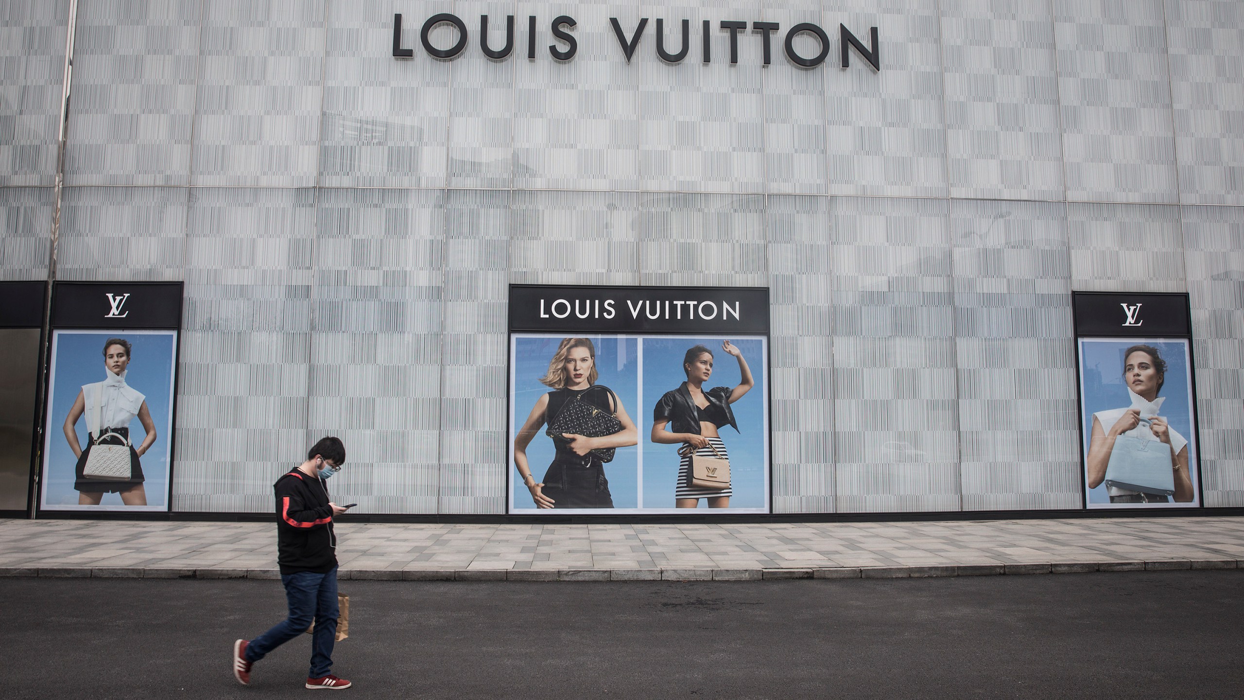 A man wearing a face mask passes a Louis Vuitton store outside Wuhan international plaza on March 30, 2020, in Hubei Province, China. (Getty Images)