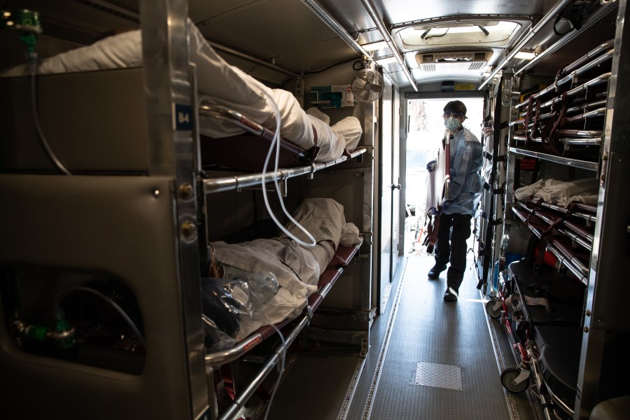 A medic prepares to unload COVID-19 patients arriving to the Montefiore Medical Center Moses Campus on April 7, 2020 in the Bronx borough of New York City. (John Moore/Getty Images)