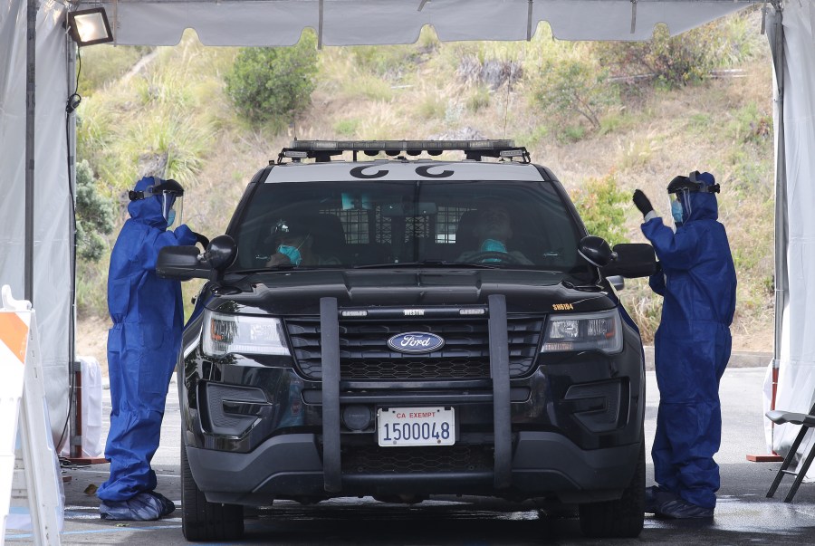 A police cruiser is seen at a drive-through coronavirus testing site at Malibu City Hall on April 8, 2020. (Mario Tama/Getty Images)