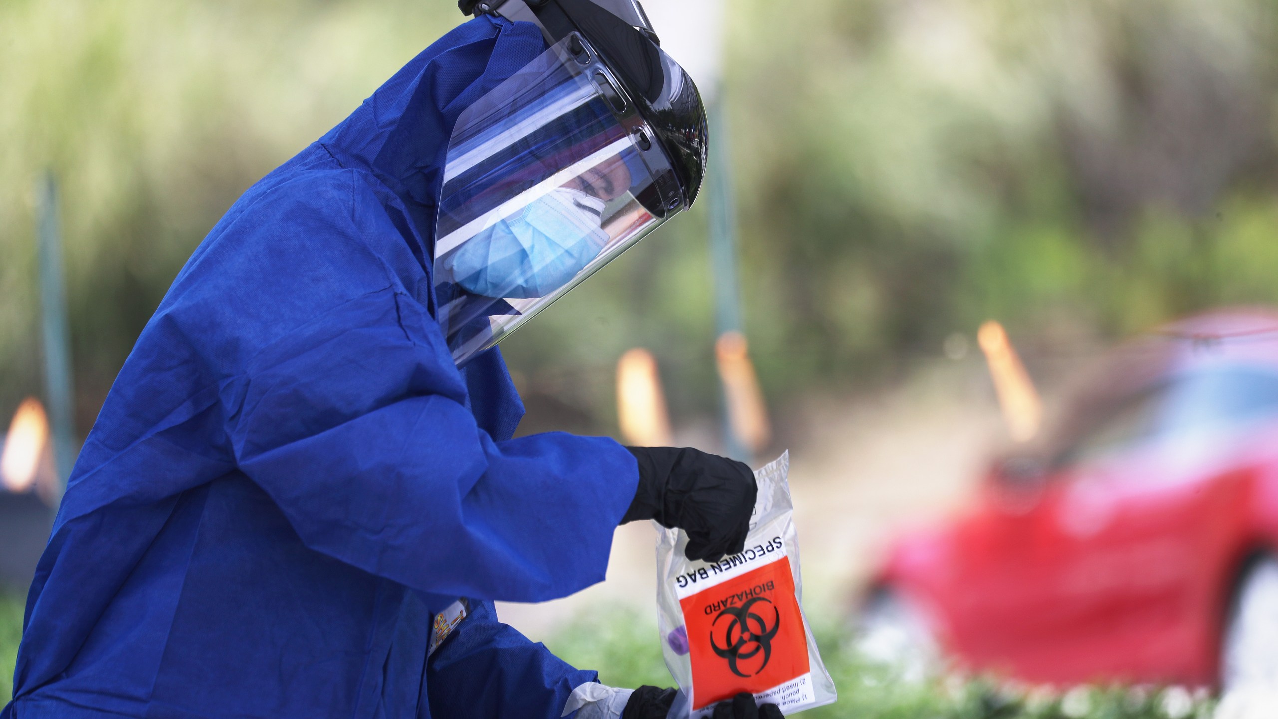 A volunteer holds a specimen bag at a drive-through coronavirus testing site outside Malibu City Hall on April 8, 2020. (Mario Tama/Getty Images)