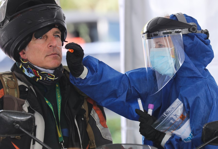 A volunteer conducts a drive-through coronavirus test at Malibu City Hall on April 8, 2020. (Mario Tama/Getty Images)