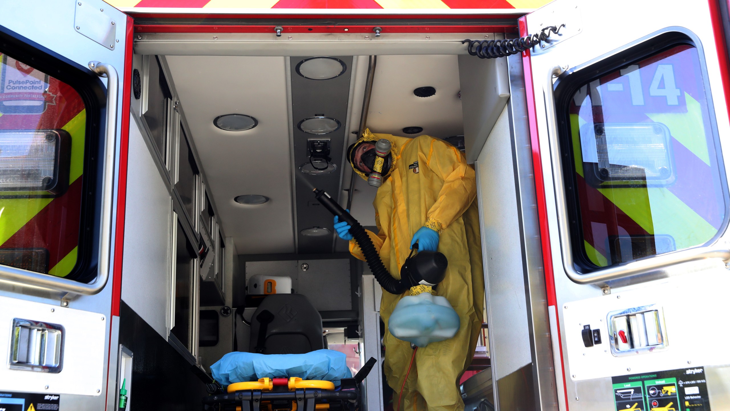 A worker with CleanHarbors sprays disinfectant inside a Marin County Fire Department ambulance on April 14, 2020 in Greenbrae. (Justin Sullivan/Getty Images)