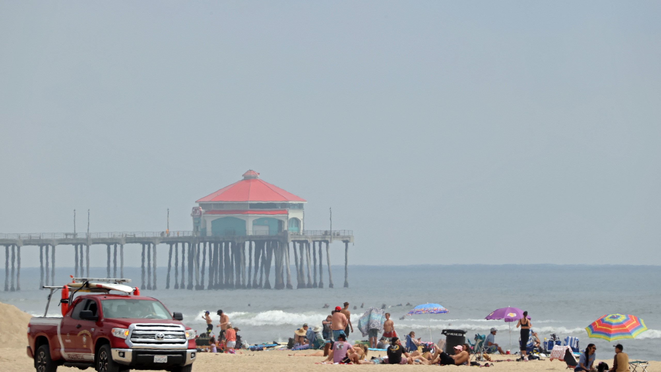 A lifeguard patrols as people gather in front of the Huntington Beach pier on April 30, 2020. (Credit: Michael Heiman / Getty Images)