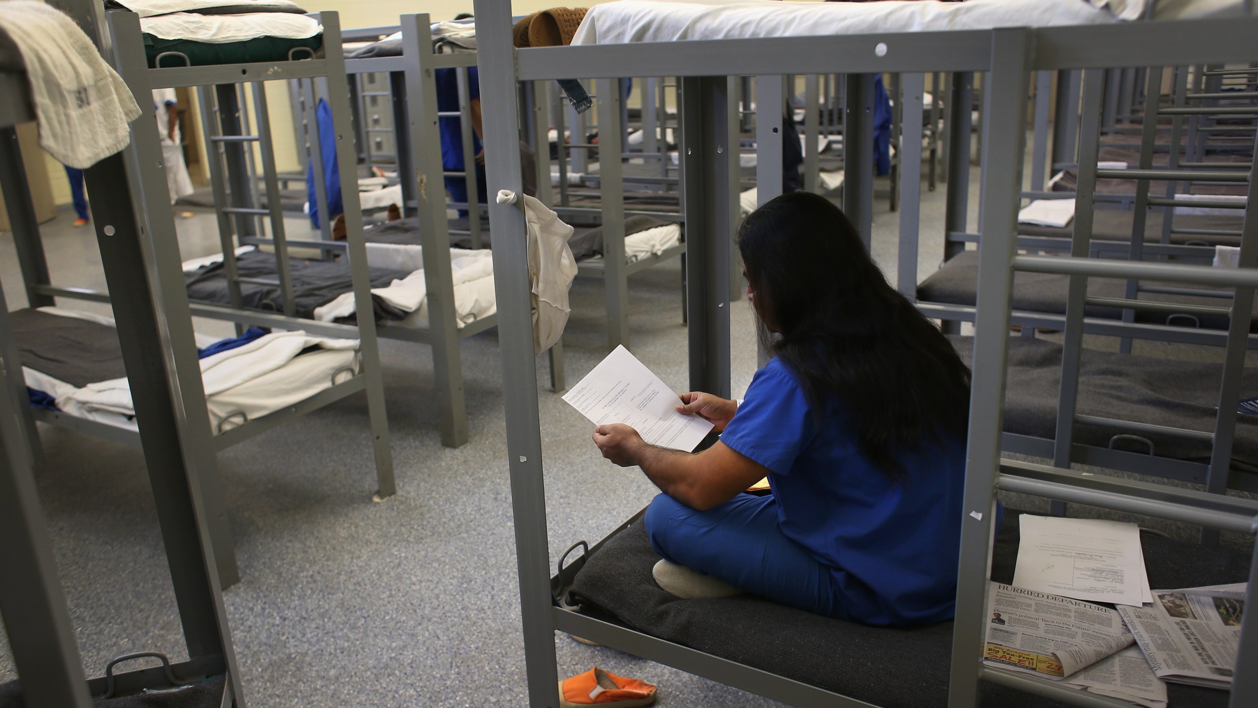 An immigration detainee from Bangladesh reads through his case papers while on his bunk at the Immigration and Customs Enforcement (ICE), detention facility on February 28, 2013 in Florence, Arizona. (John Moore/Getty Images)