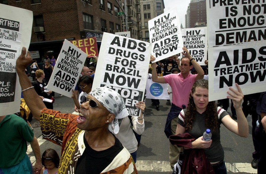 AIDS activists, church groups and anti-debt activists shout slogans as they march up Sixth Avenue in New York on June 23, 2001. (STAN HONDA/AFP via Getty Images)