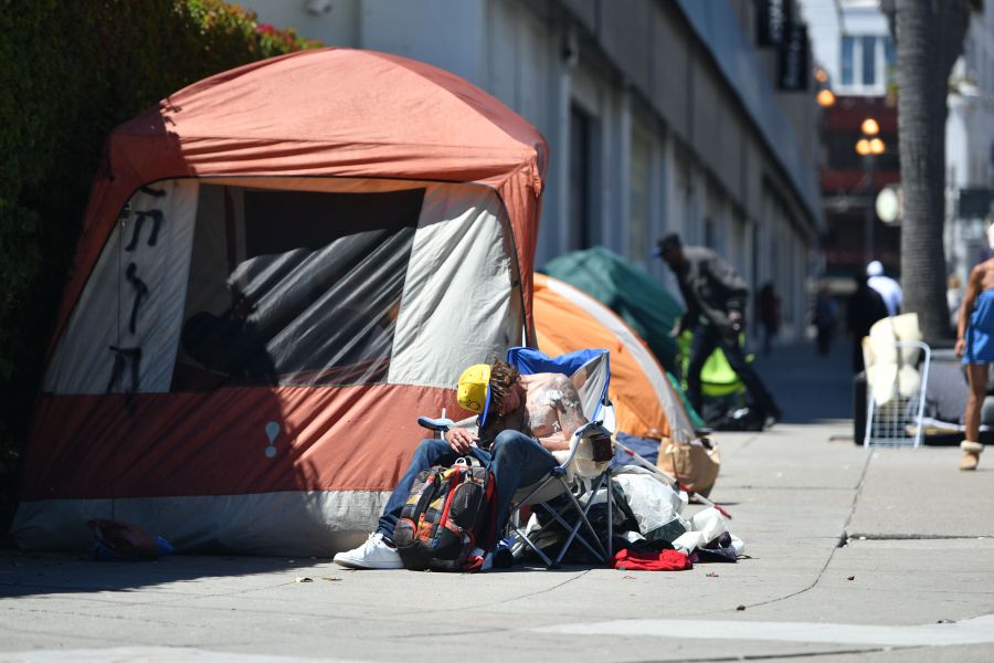 A man sleeps in front of his tent along Van Ness Avenue in downtown San Francisco, California on June, 27, 2016. (Josh Edelson/AFP via Getty Images)