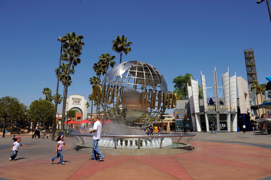 Toursits get their picture taken at the front entrance of Universal Studios Hollywood theme park on May 4, 2010. (Kevork Djansezian/Getty Images)