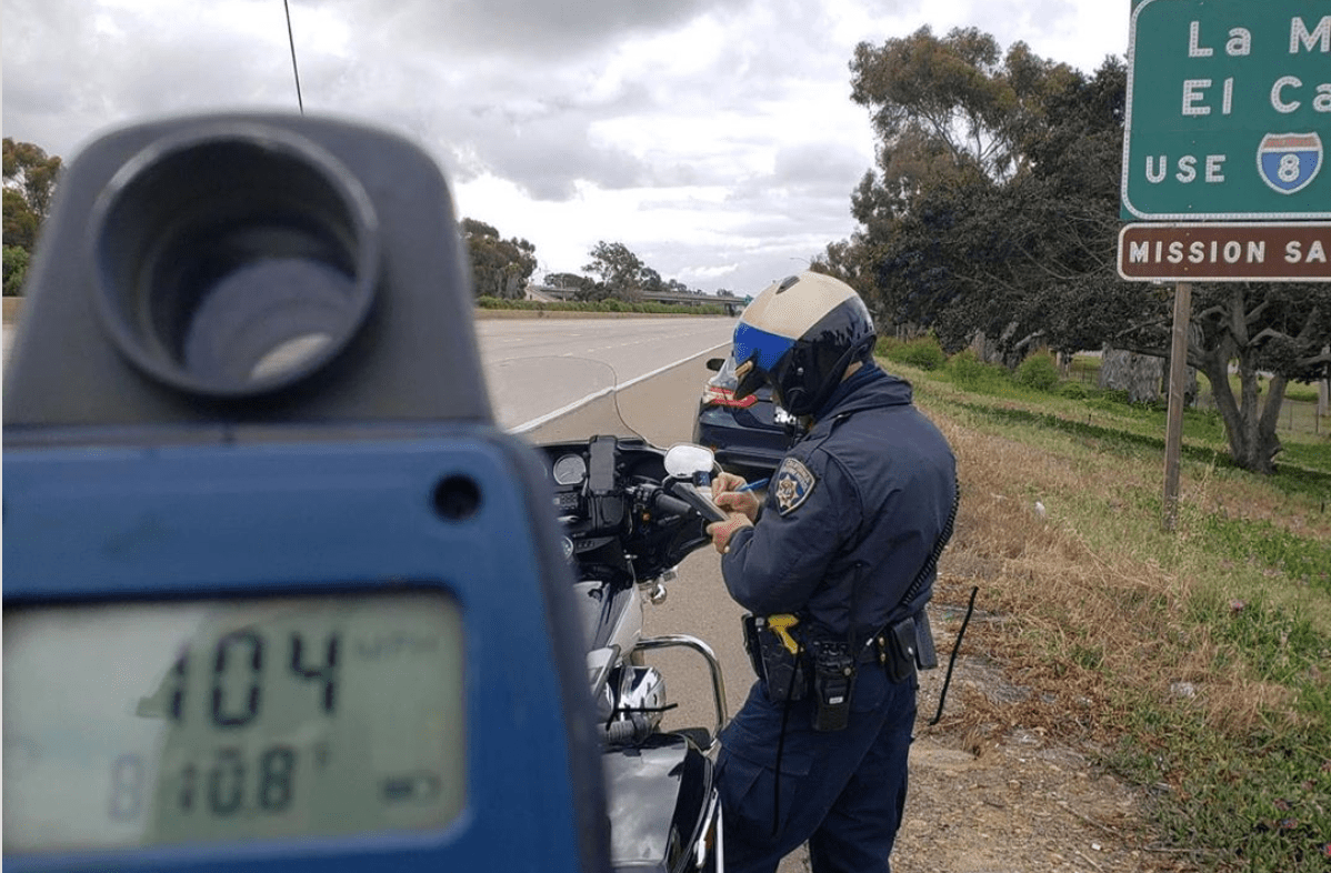 A California Highway Patrol officer issues a speeding citation on the 5 Freeway in San Diego County on April 15, 2020, in a photo released by CHP San Diego.