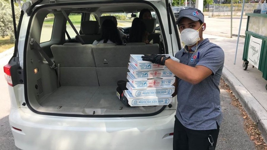 A delivery driver is seen in a picture posted to the Domino's Pizza Facebook page.