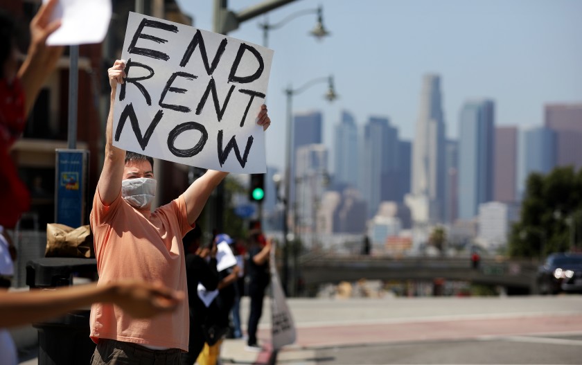 Protesters with the Los Angeles Tenants Union and other groups hold a rally at Mariachi Plaza in Boyle Heights to demand rent forgiveness for April 2020 because of the coronavirus pandemic. (Christina House/Los Angeles Times)