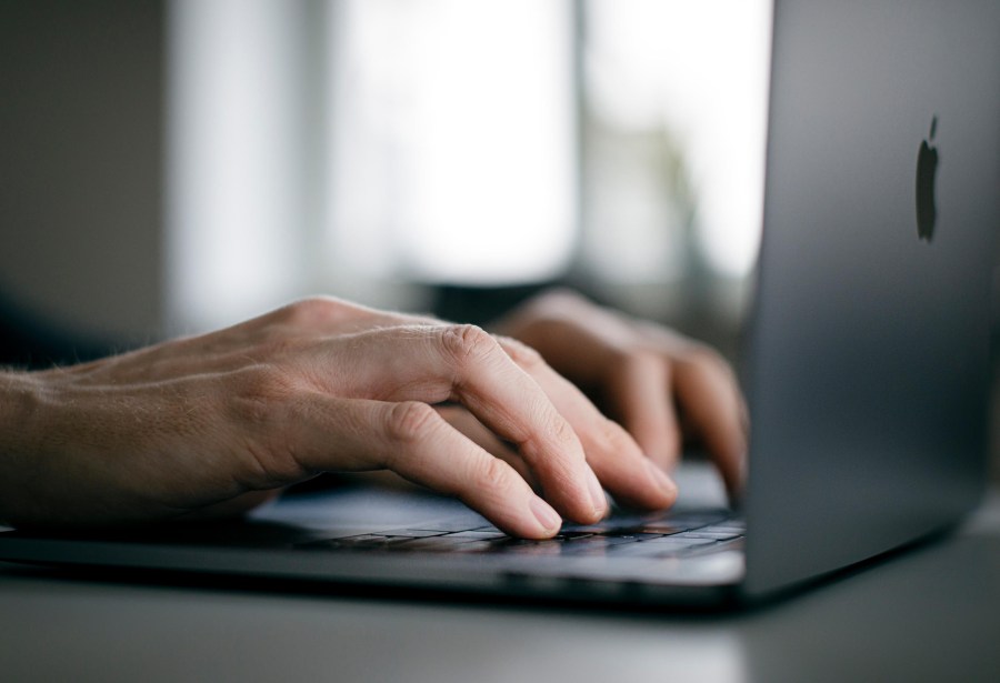 A man is typing with his hands on a keyboard of a MacBook Pro on February 04, 2020 in Berlin, Germany. (Felix Zahn/Photothek via Getty Images)