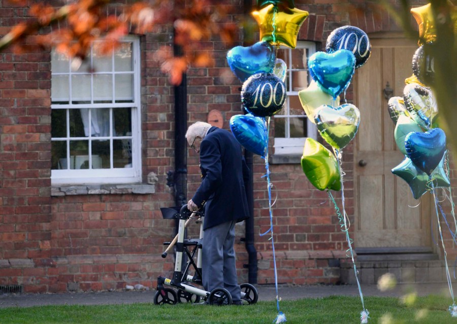 British military veteran Tom Moore, who has completed the 100th length of his garden at his home in Marston Moretaine, raising millions of pounds for the NHS with donations to his fundraising challenge from around the world, Thursday April 16, 2020. Moore started walking laps in his garden as a humble fundraising challenge to walk 100 lengths of his garden by his 100th birthday on April 30, and has now raised millions for the National Health Service and become a national rallying point during the coronavirus pandemic. (Joe Giddens/PA via AP)