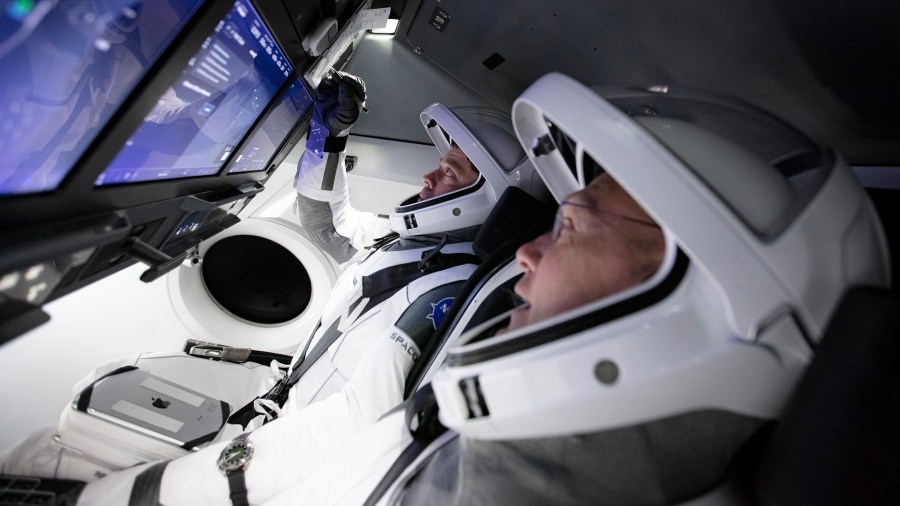 On Thursday, March 19 and Friday, March 20, SpaceX teams in Firing Room 4 at NASA's Kennedy Space Center in Florida and the company's Mission Control in Hawthorne, along with NASA flight controllers in Mission Control Houston, executed a full simulation of launch and docking of the Crew Dragon spacecraft, with NASA astronauts Bob Behnken and Doug Hurley (front) participating in SpaceX's flight simulator. (SpaceX)