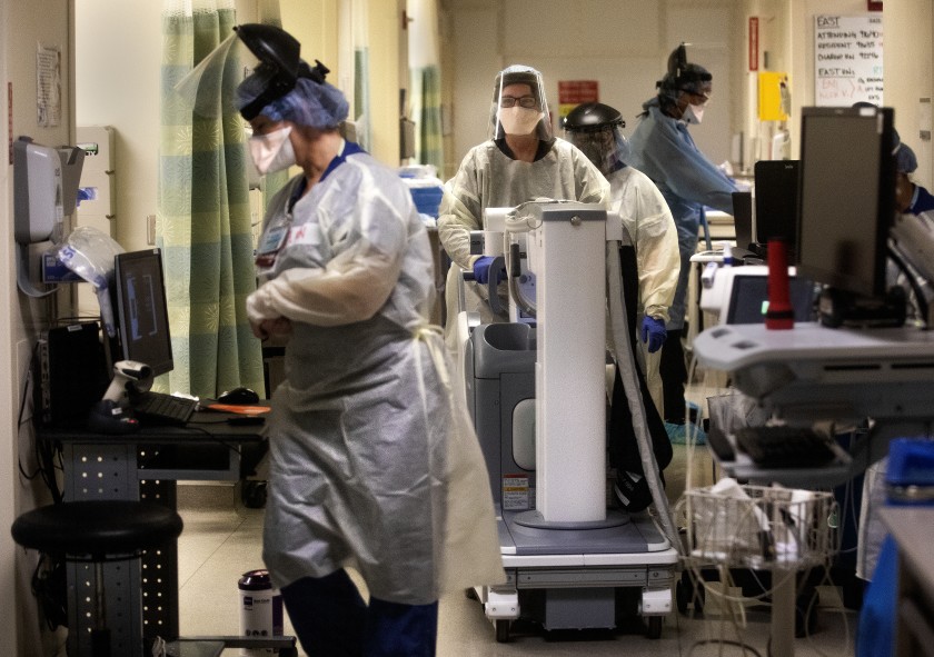 Medical staff work inside an isolation area of the emergency department at Los Angeles County+USC Medical Center in Los Angeles, where patients with COVID-19 are being treated, in 2020. (Mel Melcon / Los Angeles Times)