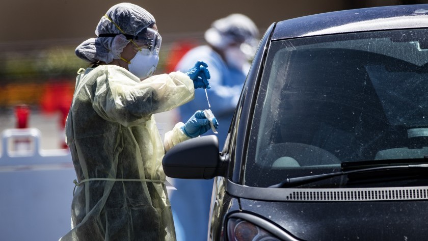 A passenger gets a coronavirus test at a drive-though facility for Coachella Valley residents in the parking lot of the Southwest church in Indian Wells last week. That site was relocated to the Riverside County Fairgrounds in Indio.(Gina Ferazzi/Los Angeles Times)