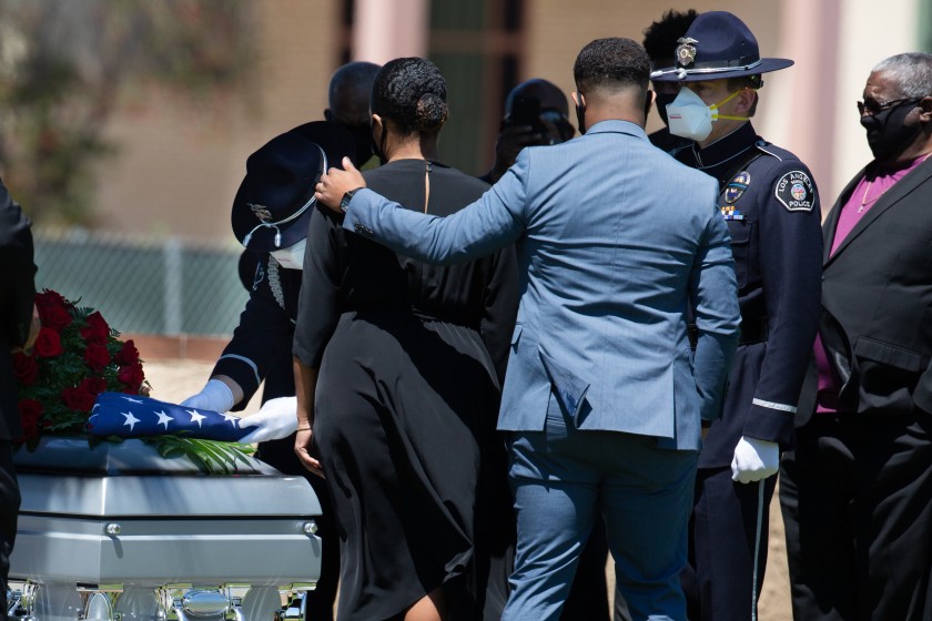 Officers from the Los Angeles School Police Department serve as honor guard and present the family with an American flag at the funeral Wednesday of retired school Police Officer Charles Jackson Jr., who died of coronavirus complications. (Jason Armond / Los Angeles Times)