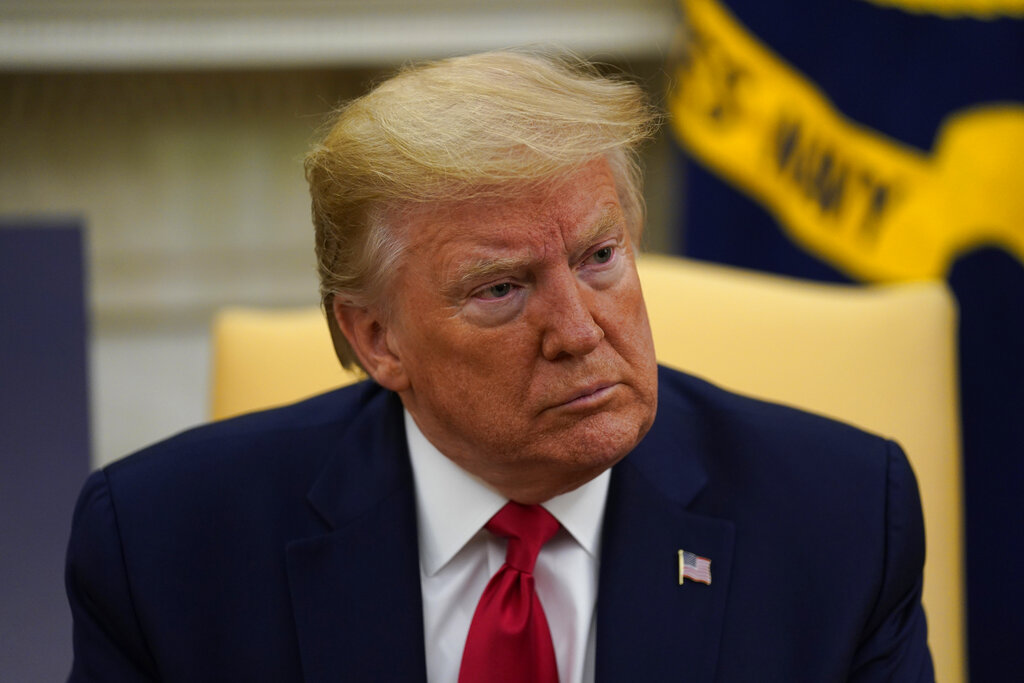 President Donald Trump listens during a meeting about the coronavirus with Louisiana Gov. John Bel Edwards, not pictured, in the Oval Office of the White House, Wednesday, April 29, 2020, in Washington. (AP Photo/Evan Vucci)