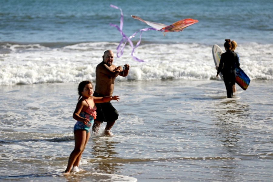 Beachgoers fly a kite at a Ventura beach amid a SoCal heat wave in late April. (Gary Coronado / Los Angeles Times)