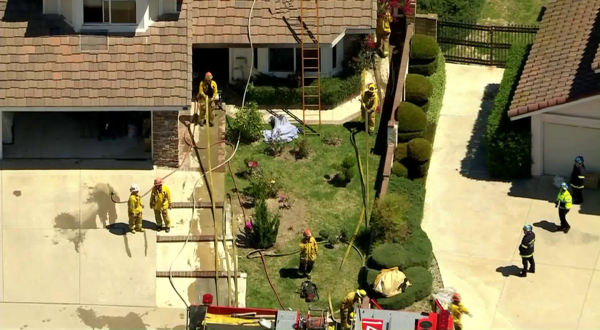 Firefighters mop up the scene of a blaze at a two-story home in Walnut on April 16, 2020. (KTLA)