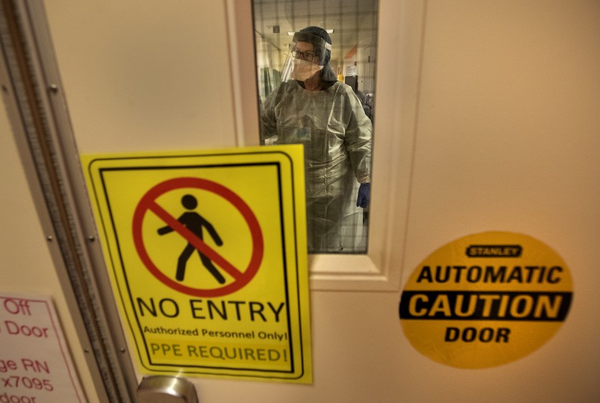 A warning sign marks the COVID-19 isolation area of the emergency department at Los Angeles County+USC Medical Center in this undated photo. (Mel Melcon / Los Angeles Times)