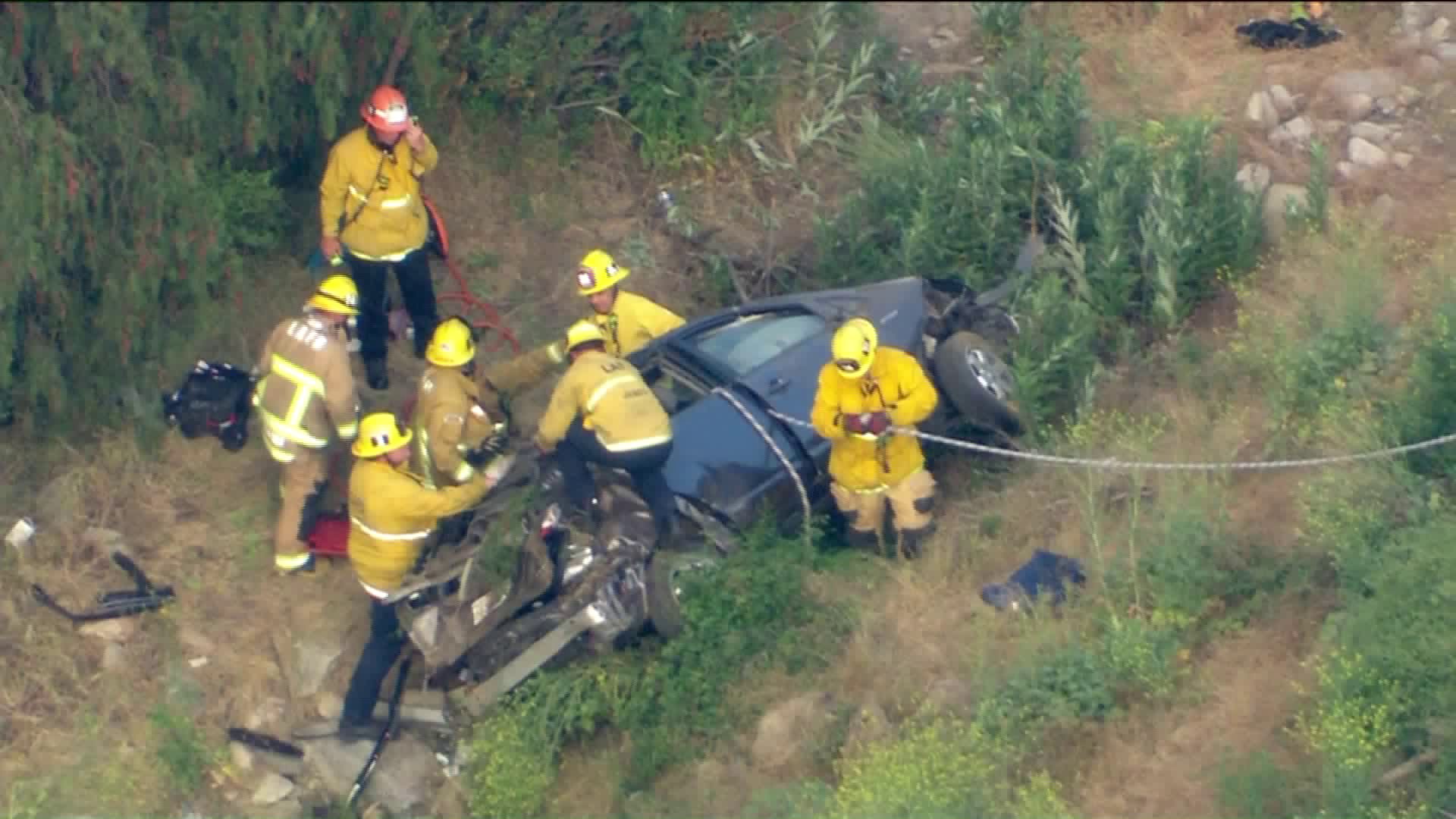 Firefighters extricated a man and a woman, both 60 years old, from inside a car that had somehow fallen 200 feet down a hillside in a residential area off of North Plainview Avenue in Tujunga. (KTLA)