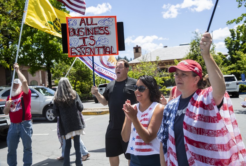 Placer County resident Jerry O’Brien holds a sign as he joins other demonstrators in a rally protesting California’s stay-at-home order on May 22, 2020. (Mel Melcon / Los Angeles Times)