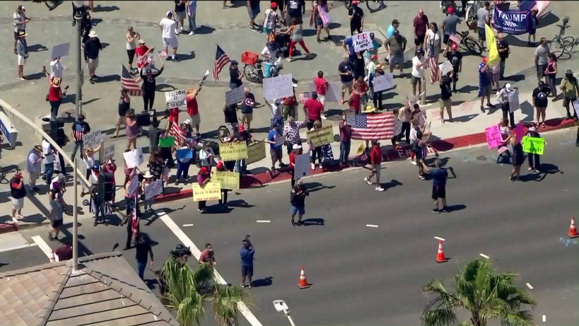 Protestors begin to gather in Huntington Beach in defiance of state's order to close Orange County beaches. (KTLA)