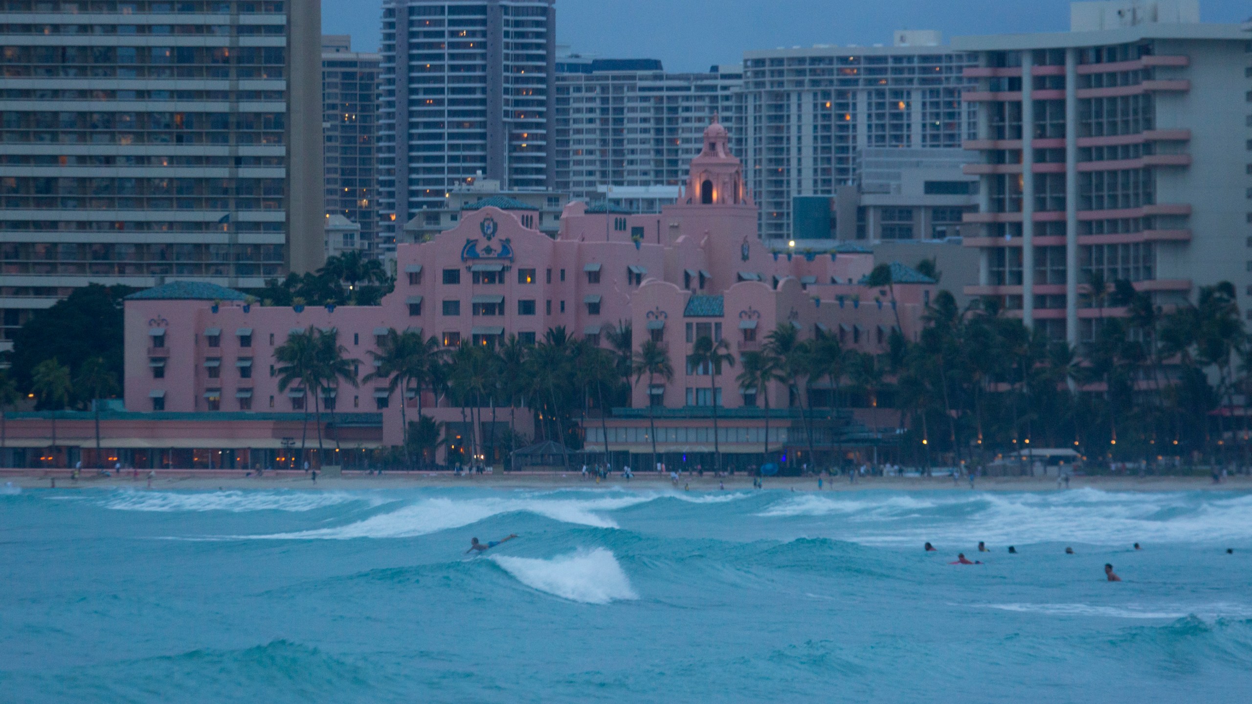 Despite warnings of dangerous rip currents and the order to stay out of the ocean, both visitors and locals continue to play in the stormy sea in front of the Royal Hawaiian Hotel brought in by Hurricane Lane as seen from the East end of Waikiki Beach on August 24, 2018. (Kat Wade/Getty Images)