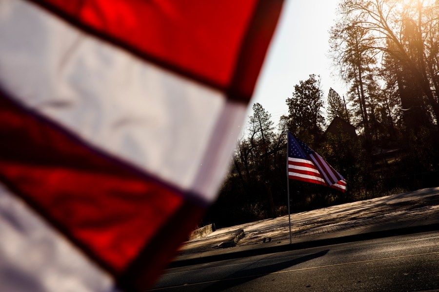 American flags flew along Skyway Road, in Paradise, California on Nov. 8, 2019 in Butte County. (Philip Pacheco/Getty Images)