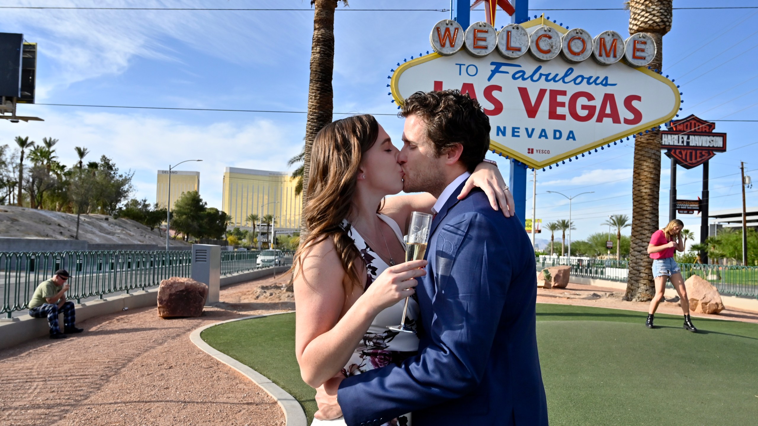 Las Vegas residents Elizabeth Billington, left, and Kenneth Quirk kiss as they celebrate what would have been their wedding day at the Welcome to Las Vegas sign on April 25, 2020. (David Becker / AFP / Getty Images)