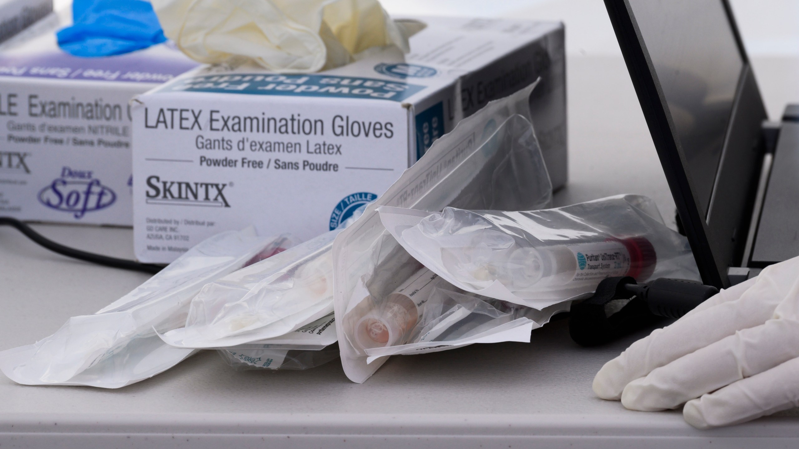 Nasal swab test kits and medical gloves are seen at a COVID-19 testing station in Compton on April 28, 2020. (ROBYN BECK/AFP via Getty Images)