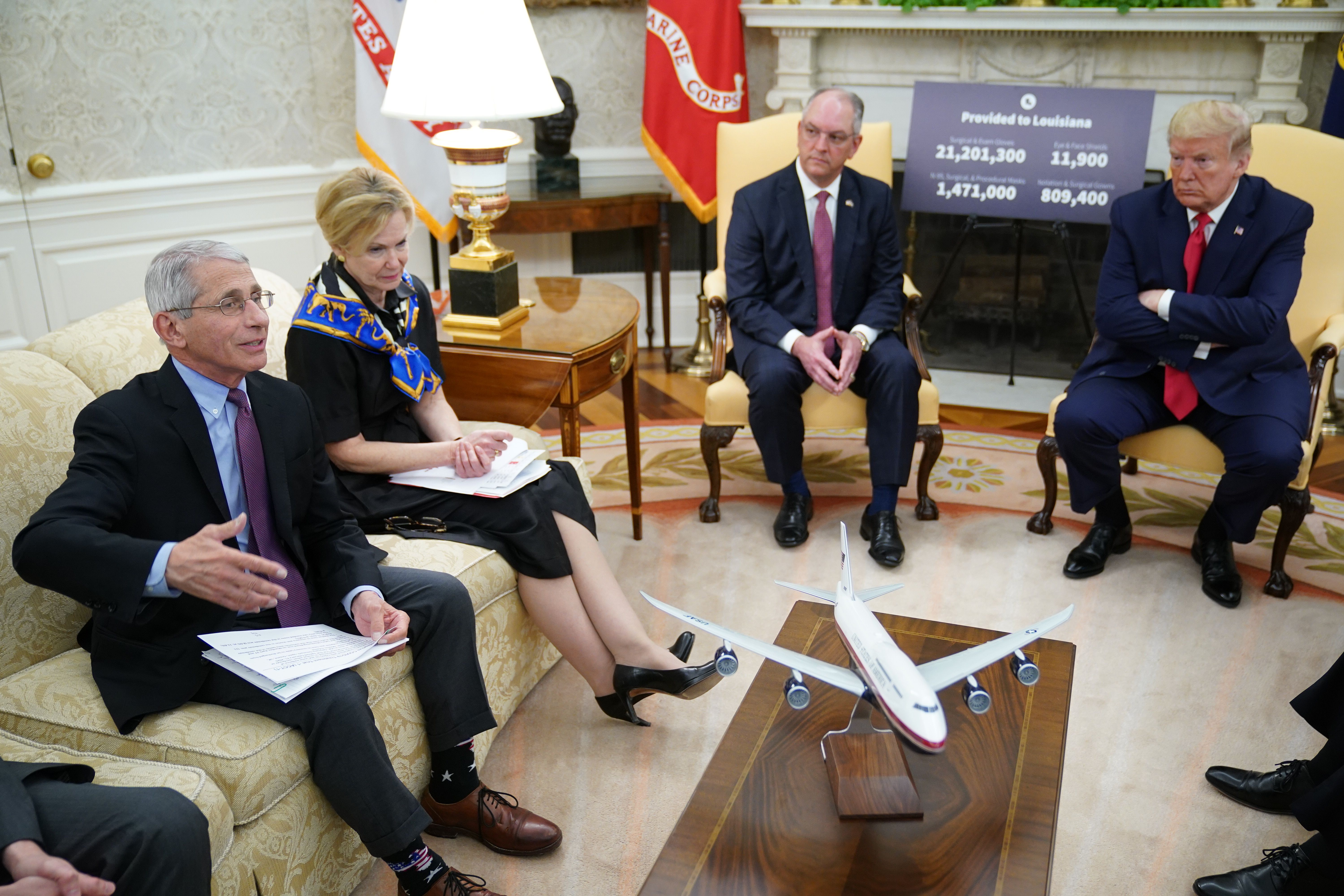 Dr. Anthony Fauci, left, director of the National Institute of Allergy and Infectious Diseases, speaks next to response coordinator for White House coronavirus task force Deborah Birx during a meeting with President Donald Trump and Louisiana Gov. John Bel Edwards, center, in the Oval Office on April 29, 2020. (Credit: Mandel Ngan / AFP / Getty Images)