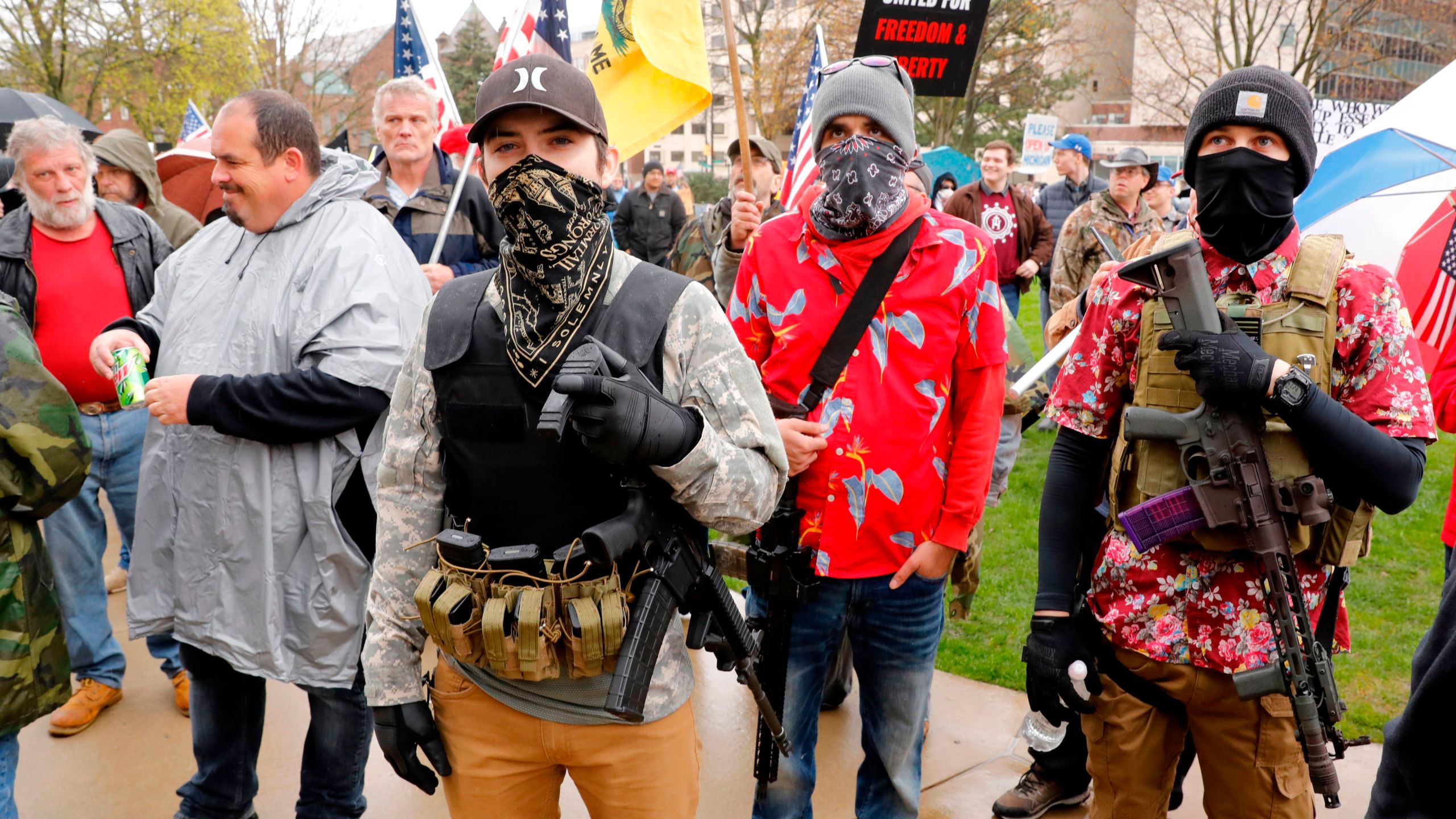 Armed protesters provide security as demonstrators take part in an "American Patriot Rally," organized on April 30, 2020, by Michigan United for Liberty on the steps of the Michigan State Capitol in Lansing, demanding the reopening of businesses. (JEFF KOWALSKY/AFP via Getty Images)