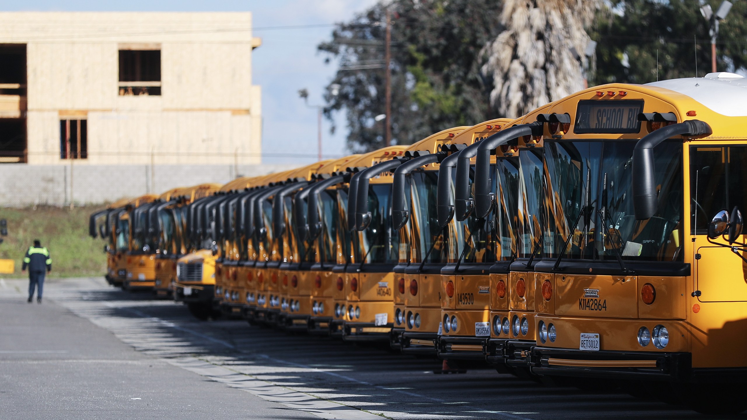 School buses are seen parked in a lot while schools schools stay closed in response to the coronavirus outbreak, on March 17, 2020, in Gardena. (Mario Tama/Getty Images)