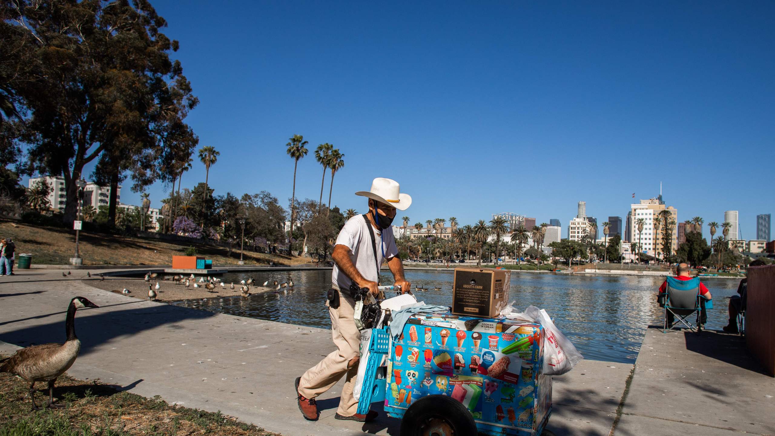 A ice-cream street vendor pushes his cart in MacArthur Park, Los Angeles on May 21, 2020. (APU GOMES/AFP via Getty Images)