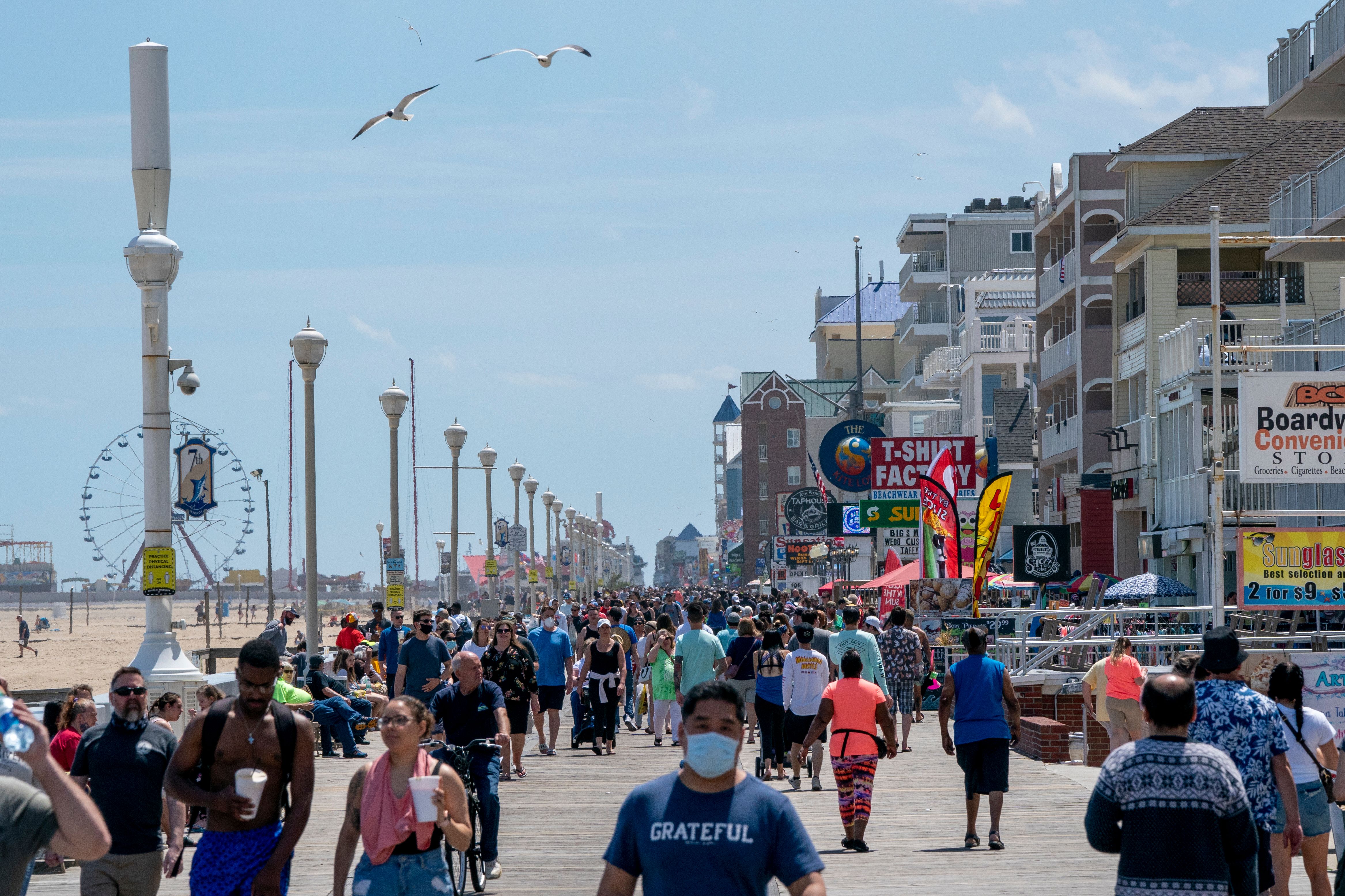 People enjoy the boardwalk during the Memorial Day holiday weekend amid the coronavirus pandemic on May 23, 2020 in Ocean City, Maryland. (ALEX EDELMAN/AFP via Getty Images)