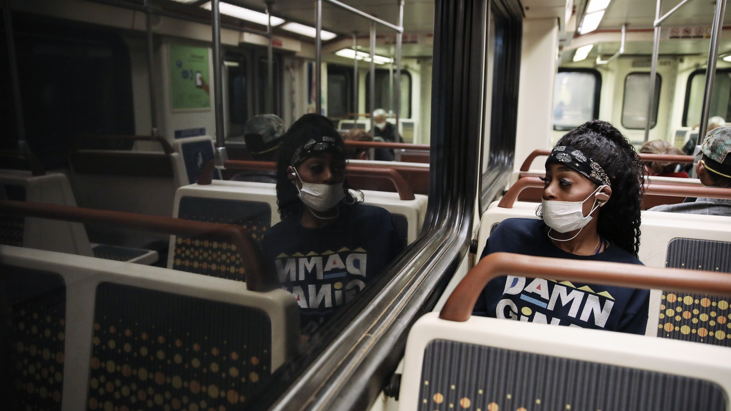 A woman wears a face mask while riding a Los Angeles Metro Rail train amid the coronavirus pandemic on April 1, 2020, in Los Angeles. (Mario Tama/Getty Images)