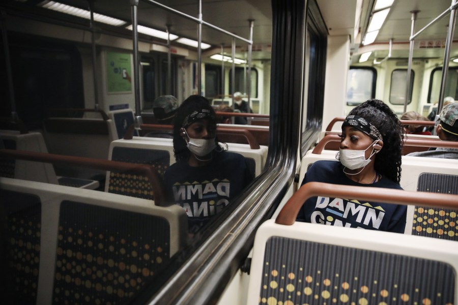 A woman wears a face mask while riding a Los Angeles Metro Rail train amid the coronavirus pandemic on April 1, 2020, in Los Angeles. (Mario Tama/Getty Images)