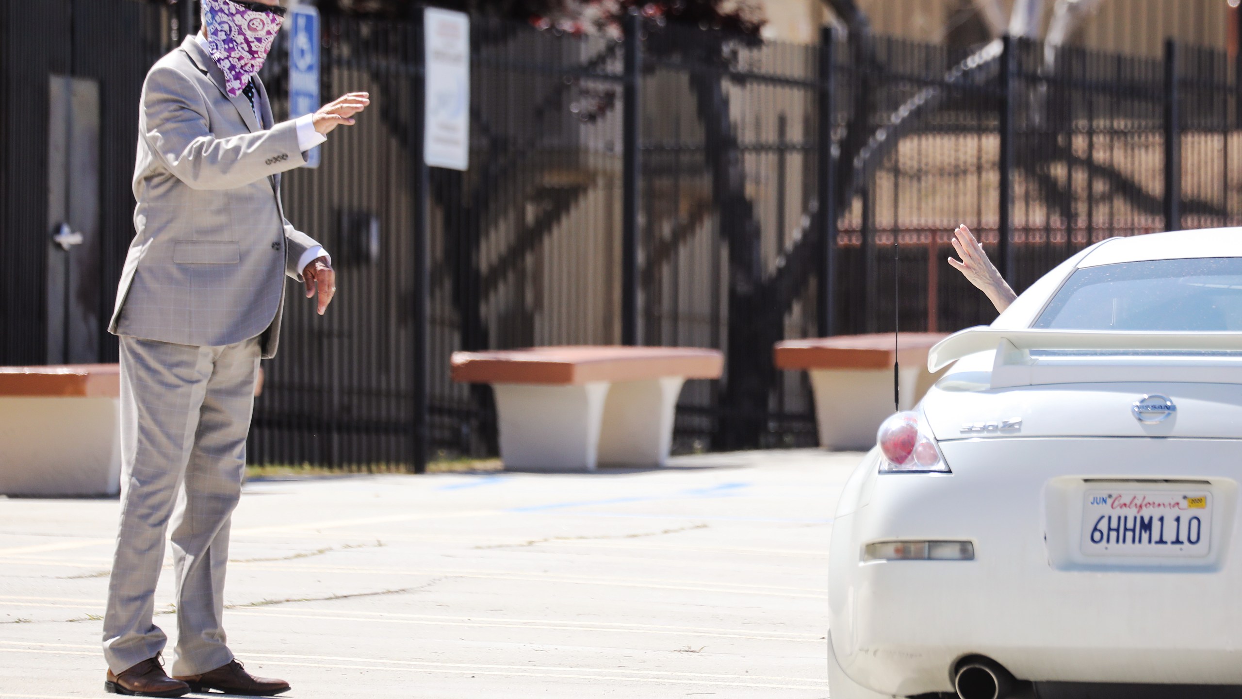 Pastor Jerel Hagerman (L) waves to a departing congregant after conducting a drive-in ‘car church’ Easter service in the parking lot of Joshua Springs Calvary Chapel amidst the coronavirus pandemic on April 12, 2020 in Yucca Valley, California. (Mario Tama/Getty Images)