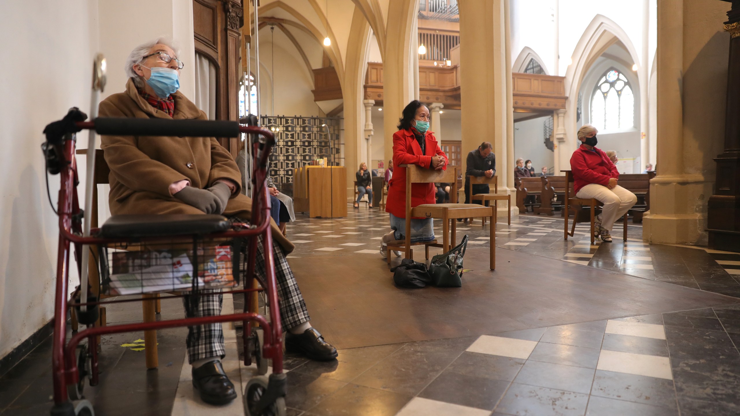 A limited number of people, wearing protective face masks, attend a Sunday mass by Dean Wolfgang Picken at St. Remigius Catholic church for the first time since March during the novel coronavirus crisis on May 3, 2020 in Bonn, Germany. (Andreas Rentz/Getty Images)